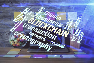 Double exposure of blockchain and crypto economy theme hologram and table with computer background....