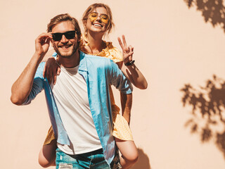 Portrait of smiling beautiful girl and her handsome boyfriend. Woman in casual summer dress and man...