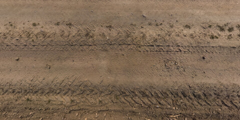 view from above on texture of gravel road with car tire tracks