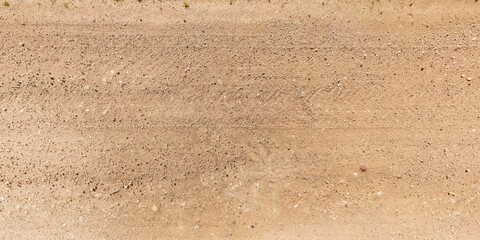 view from above on texture of gravel road with car tire tracks - Powered by Adobe