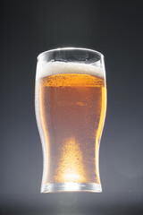 Glass of beer on black background, copy space