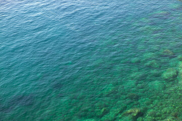 top view of sea clear water with stones on the bottom