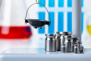 Laboratory scales with weights against test tubes