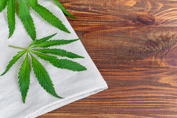 Cannabis fabric and rope on wooden background. Industrial production.