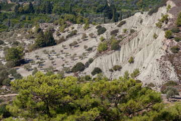 Fototapeta na wymiar Panoramic view of the rocky hills on the island of Rhodes in Greece. The concept of trekking, Hiking and rock climbing. Travel around the world. Mountain landscape with Olive trees and pines
