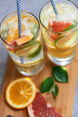 Infused detox water with grapefruit, orange, lemon and lime and ice in glasses 