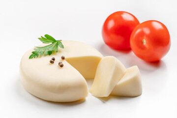 Suluguni (sulguni) cheese with tomatoes on white background. snack food