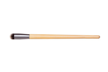 Closeup of a wooden new professional makeup brush isolated on a white background. Concept beauty. Macro photograph.