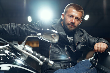 Portrait of motorbike rider in black leather outfit