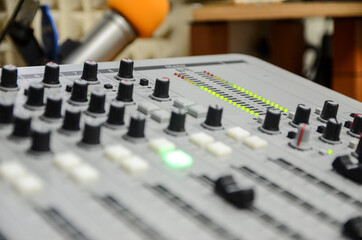 Mixer in radio station. Close up of professional multitrack mixing console in production studio....