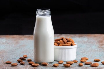Almond milk with Almond seeds. Almond milk in a bottle with almonds