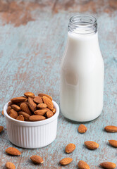 Almond milk with Almond seeds. Almond milk in a bottle with almonds