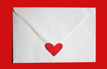 Valentine's day, love letter, white envelope with red paper heart on red background