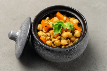 Vegetarian pilaf gray in a pot decorated with greens