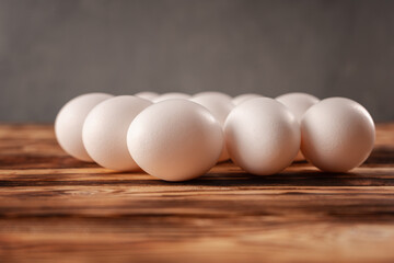 White eggs on a wooden plank table. © Роман Самсонов