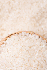 Raw rice in a bowl and full frame in the white background table, top view overhead shot, close up