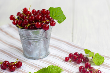 Red currants on a light wooden background. Vitamin cocktail.