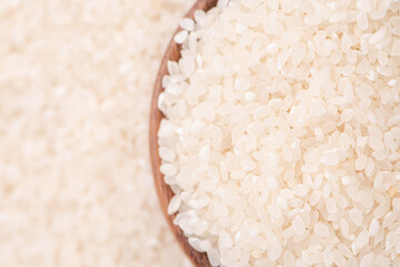 Raw rice in a bowl and full frame in the white background table, top view overhead shot, close up