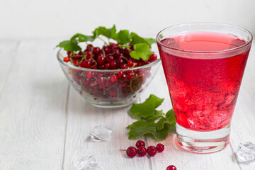 Red currants on a light wooden background. Vitamin cocktail.