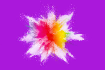 Fototapeta na wymiar Explosion of colored powder isolated on purple background. 
