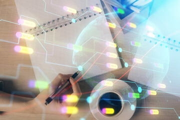 Multi exposure of hands making notes with world map hologram and data theme icons. Concept of global data.