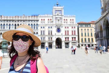 Beautiful tourist woman with red surgical mask and straw hat and