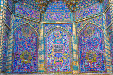 Famous pink mosque decorated with mosaic tiles and religious calligraphic scripts from Persian Islamic Quran, Shiraz, Iran. 