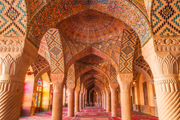 Famous pink mosque decorated with mosaic tiles and religious calligraphic scripts from Persian Islamic Quran, Shiraz, Iran. 