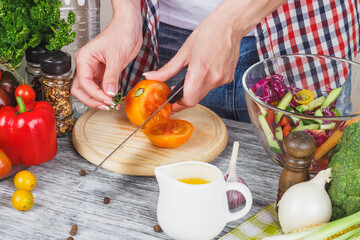 Woman cooks at the kitchen, body part