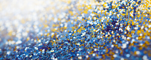 Gold and blue glitter shine dots confetti. Abstract light blur blink sparkle defocus backgound.