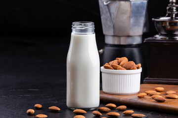 Almond milk with Almond seeds. Almond milk in a bottle with almonds