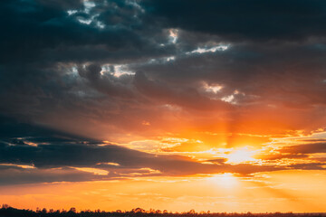Sun Shine During Sunset Above Empty Spring Countryside Rural Soil Landscape. Field Under Sunny Spring Sky. Agricultural Landscape With Copy Space