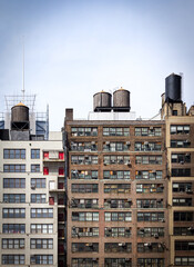 Old brick apartment buildings with rows of windows in Midtown Manhattan New York City and empty...