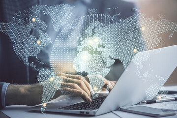 Multi exposure of businessman working on laptop on background. International business hologram in front. Concept of success.