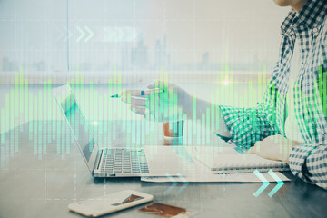 Multi exposure of stock market chart with man working on computer on background. Concept of financial analysis.