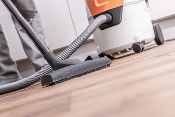 Fototapeta na wymiar Hardwood Floor Vacuuming Inside Apartment