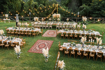 Wedding table set up in boho style with pampas grass and greenery