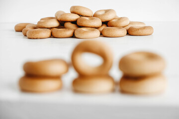 Drying or mini round bagels on a white wooden background. Copy, empty space for text