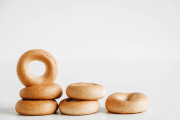 Drying or mini round bagels on a white wooden background. Copy, empty space for text
