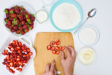 step by step recipe strawberry cobbler homemade from ripe fresh strawberries and shortbread on a light background, top view. ingredients for strawberry pie