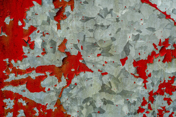 Peeling red paint on a old dirty metal surface