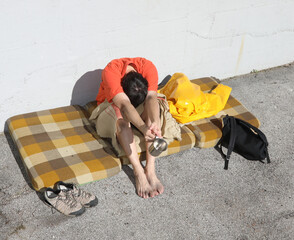 homeless man asks for charity for a long time on a street of the
