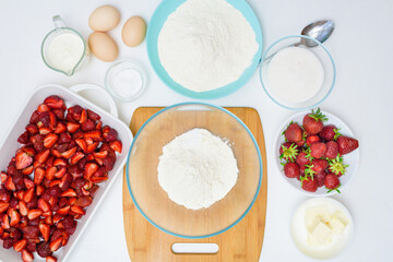 step by step recipe strawberry cobbler homemade from ripe fresh strawberries and shortbread on a light background, top view. ingredients for strawberry pie