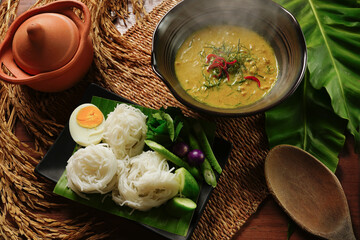 Thai Rice Noodles with crab green curry with boiled egg and Variety Vegetables on Thai ancient background