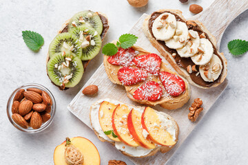 Sweet sandwiches with fruits and berries on white background.