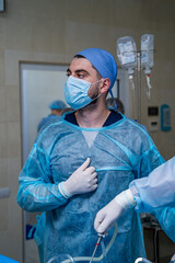 Portrait of a surgeon at working place. Real time photo. Operation process.