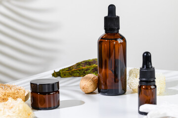 Skincare products containers on a white background with creative shadows