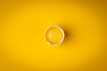 White egg on yellow background.