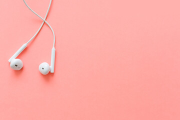 Obraz na płótnie Canvas Flat lay concept: headphones on pastel backgrounds. headphones on a pink background, top view, copyspace. Trendy colorful photo. Minimal style with colorful paper backdrop.