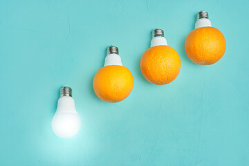 led light bulb. oranges in a lamp on a turquoise background